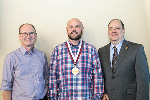 Pictured during a ceremony naming Matthew W. Brown to the Dr. Donald L. Hall Professorship are, from left, Angus Dawe, professor and head of MSU’s Department of Biological Sciences; Brown; and Dean of MSU’s College of Arts and Sciences Rick Travis.